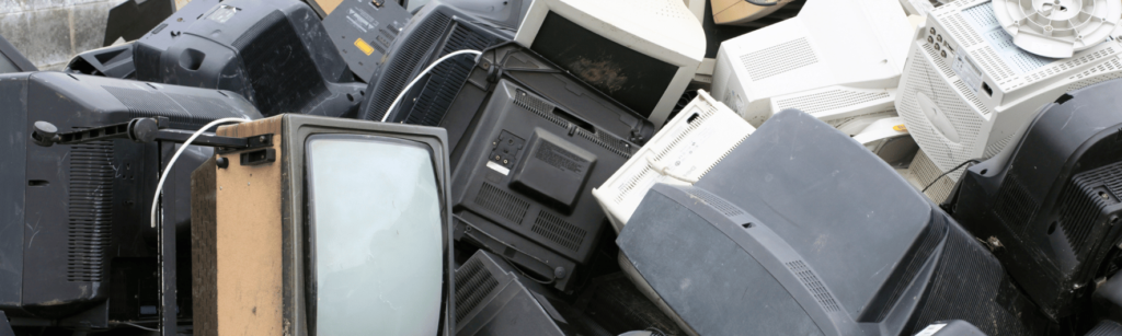 Decommissioned CRT monitors and vintage computer terminals staged for certified IT asset disposition and e-waste recycling