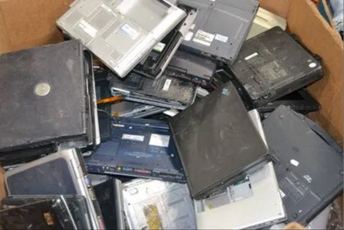 Sell old laptops as e-waste scrap in Hyderabad 1 A large cardboard storage bin filled with a bulk lot of decommissioned corporate laptops and old notebook computers piled up for asset liquidation